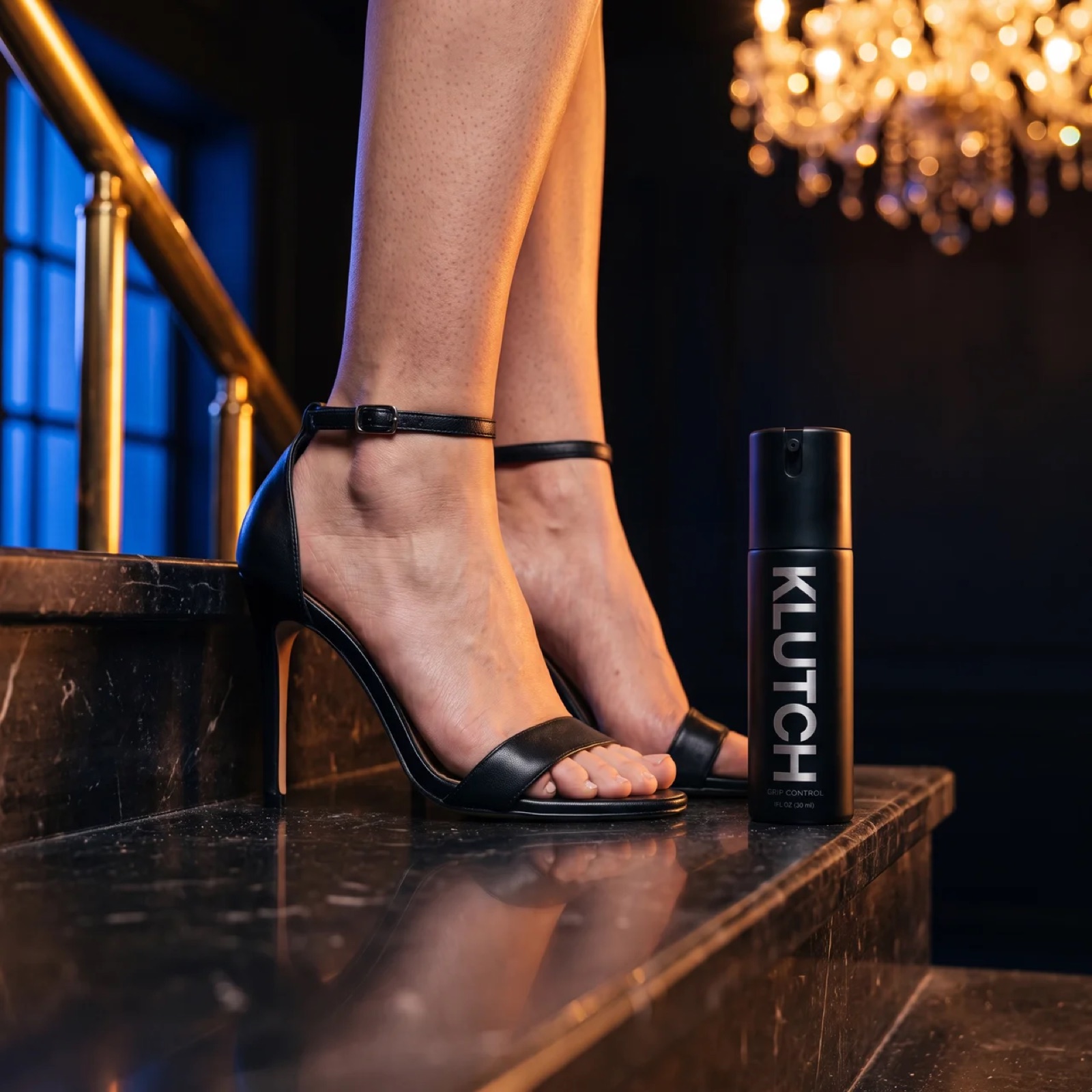 Feet in heels on a marble staircase beside the Klutch Grip Control bottle
