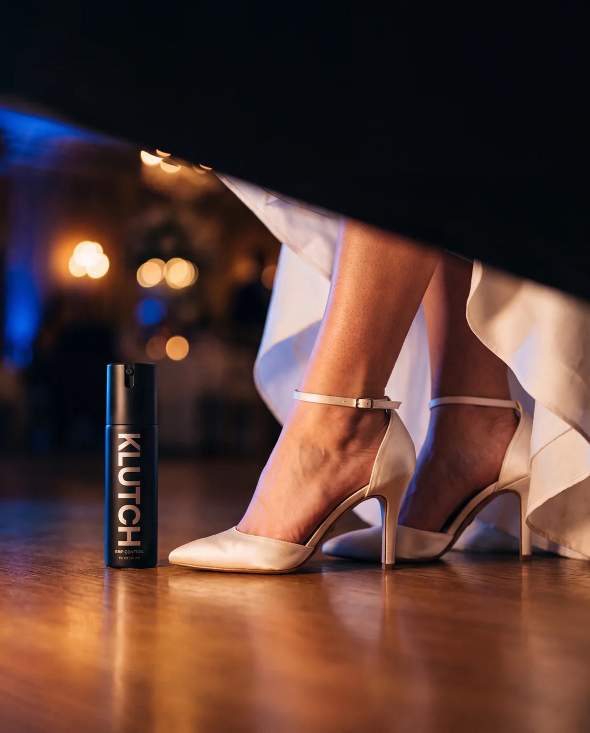 Bride in ivory heels beside the Klutch bottle